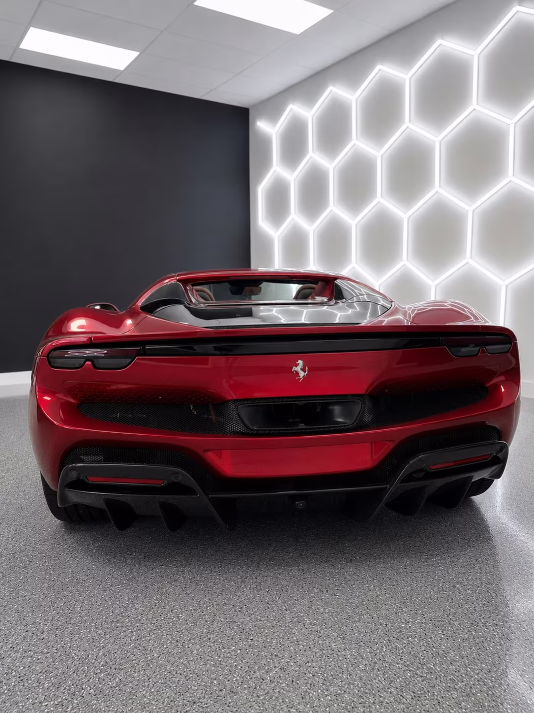 Red Ferrari, rear, in the bay
